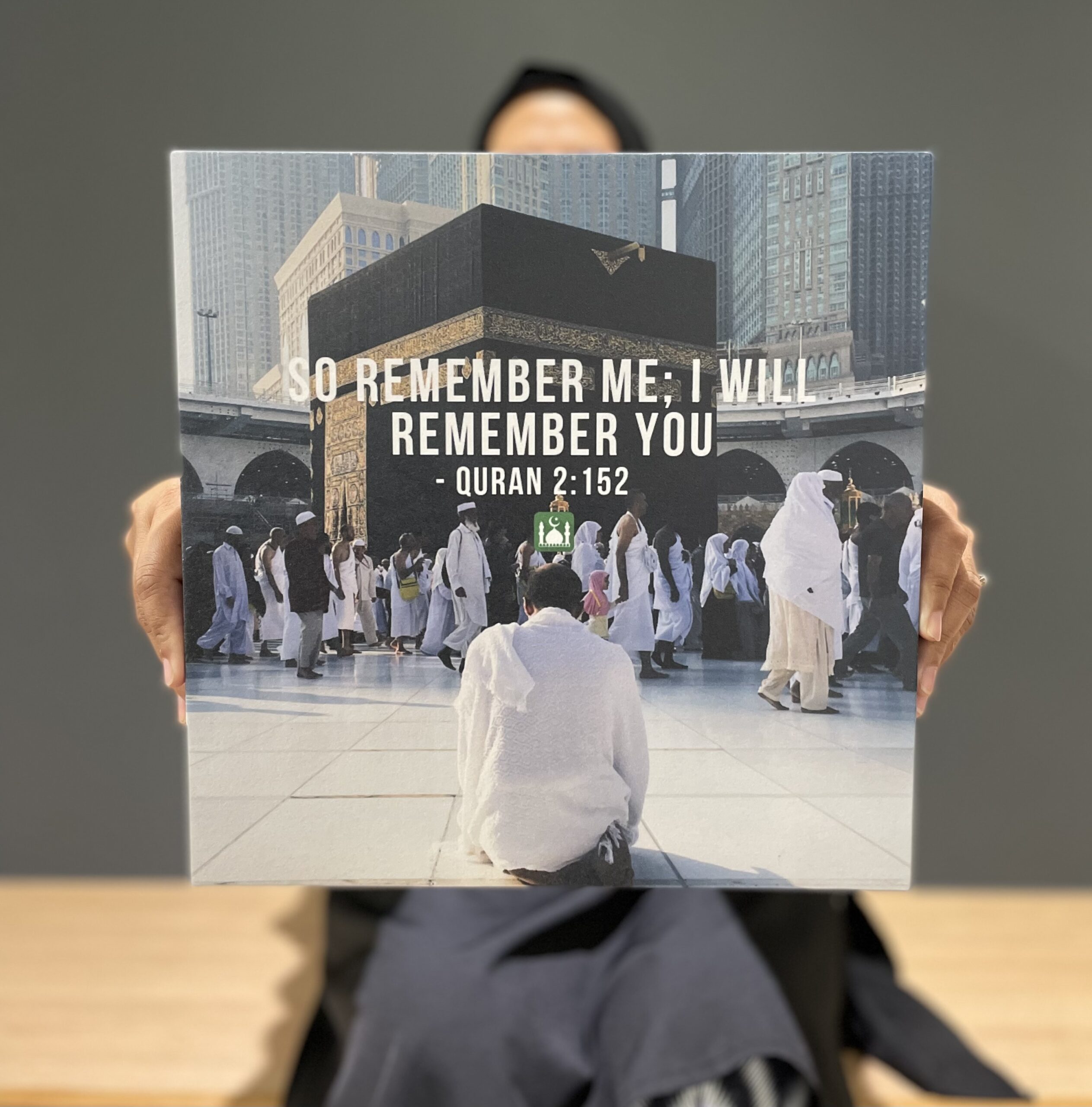 verse of the quran, woman holding a poster, 
