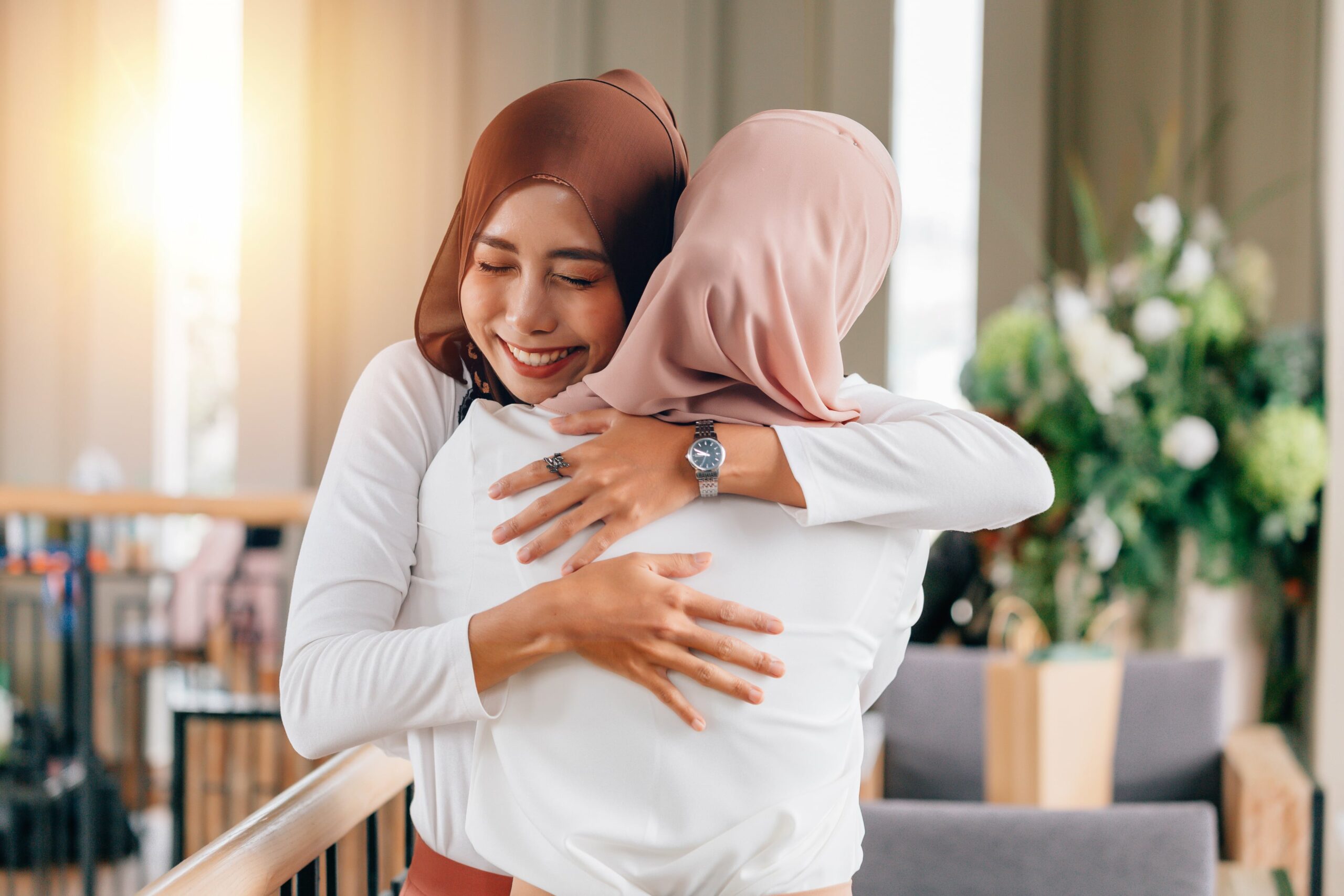 Hijabi muslim woman Strengthen Ties and Kinship through hugs and smile
