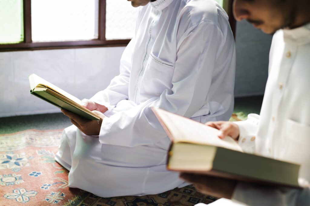 muslim men reading from the quran