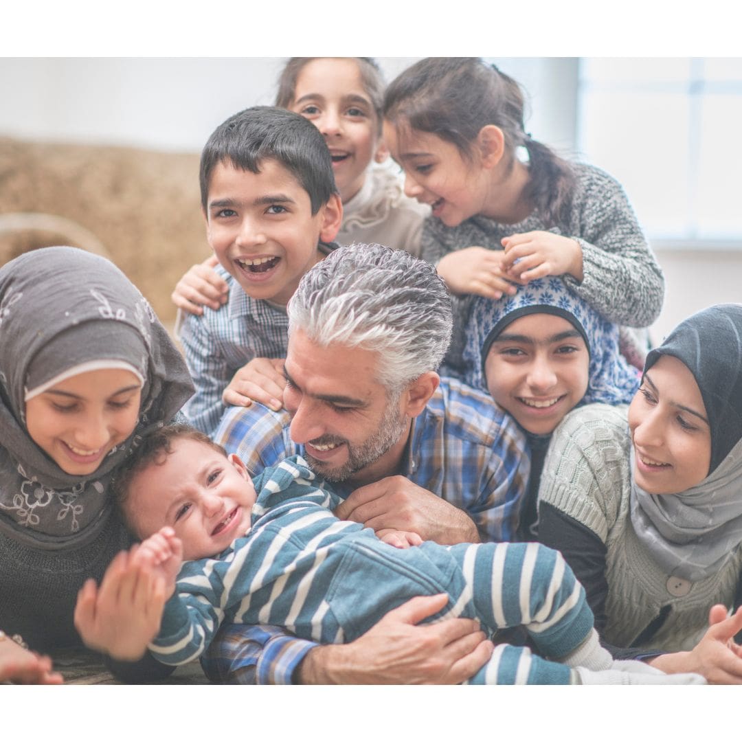 members of an Arab Muslim family smiling together