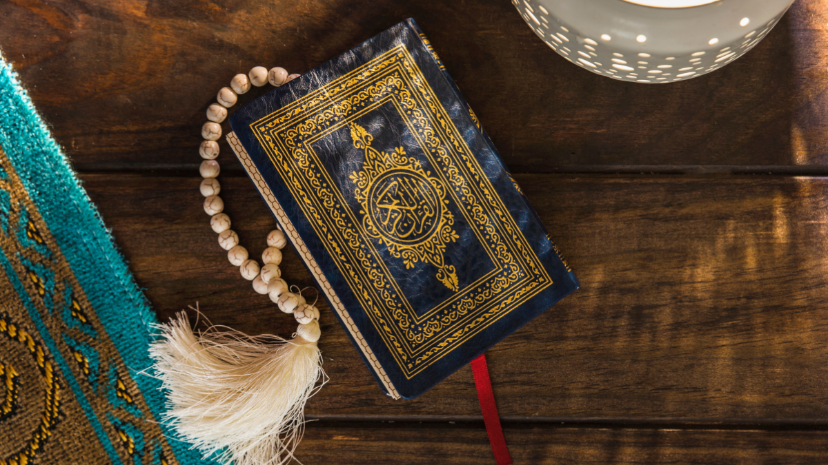 The Holy Quran placed on the table with tasbih