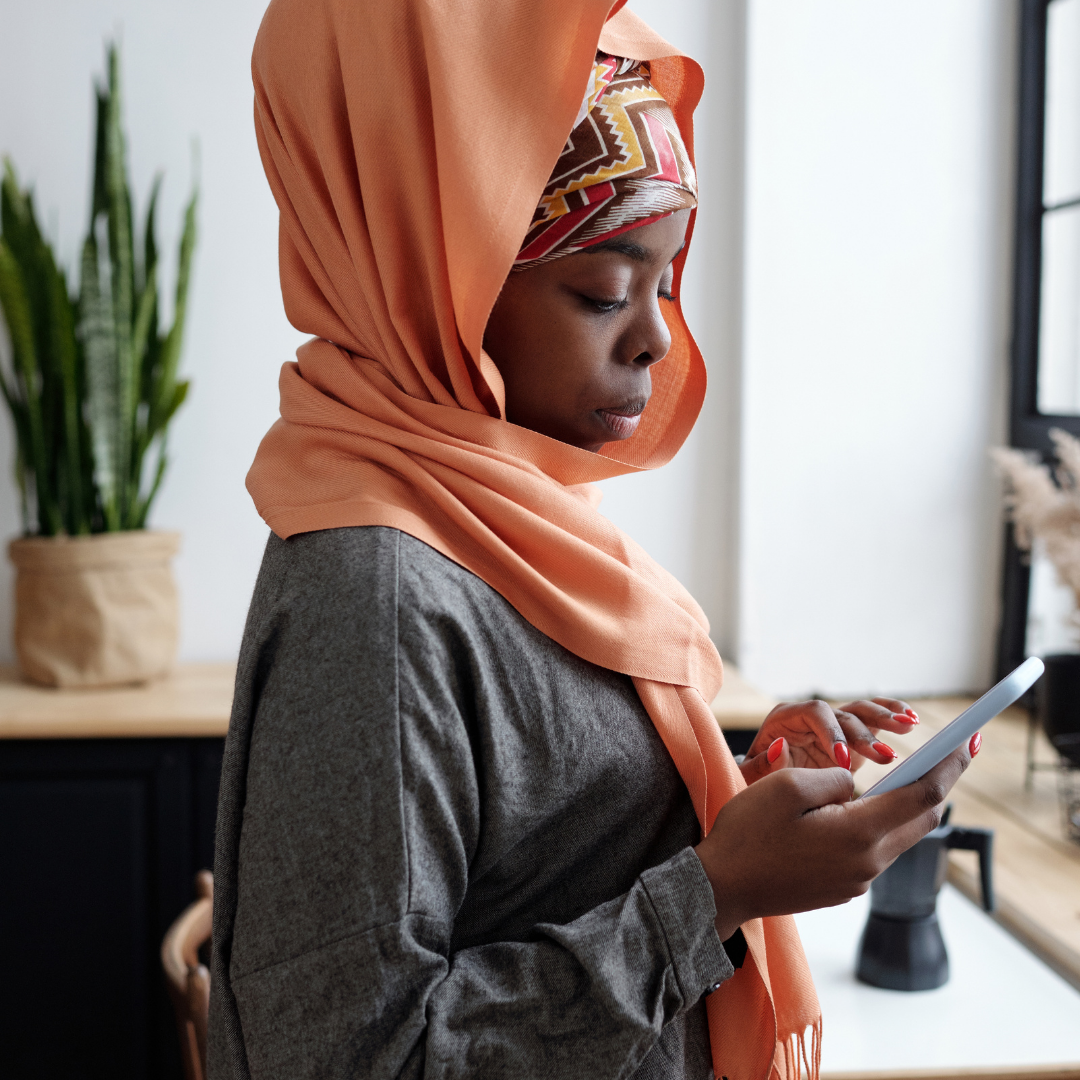 African Muslim Woman using her mobile phone