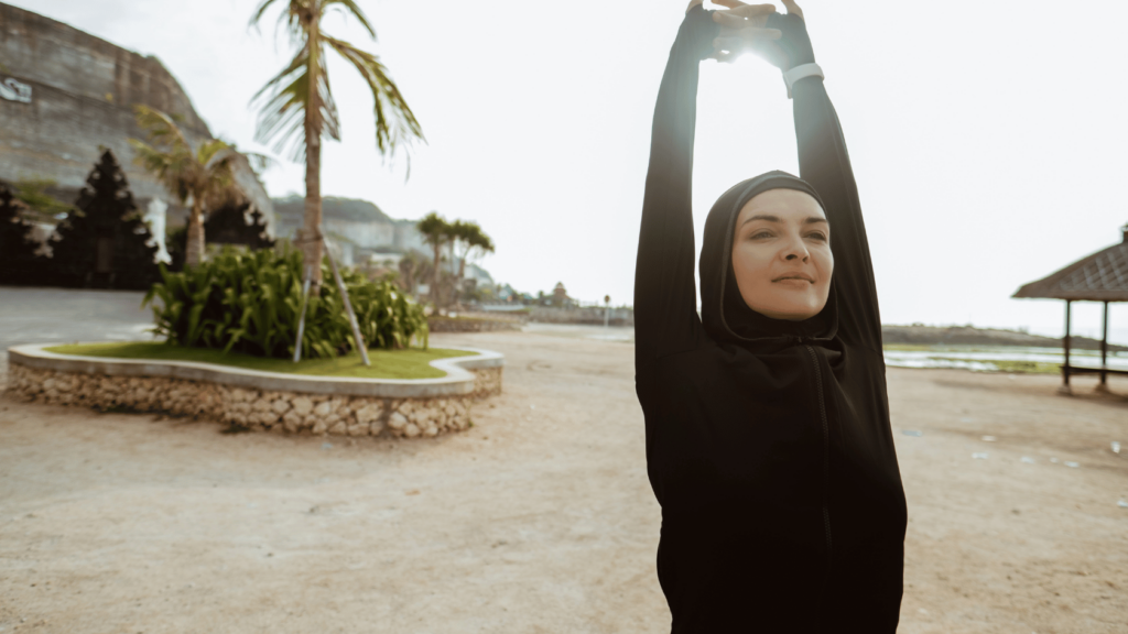 Muslim woman stretching, feeling energized after fasting
